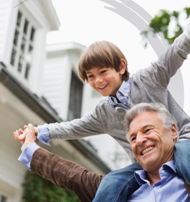 grandson sits on his grandfathers shoulders