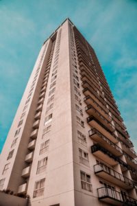 Beige high-rise apartment with balconies.