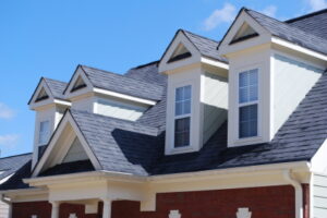 photo of a house with a new roof and row of dormers