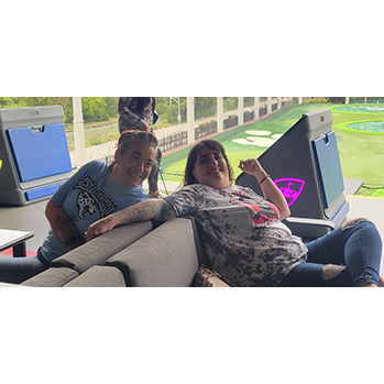 a woman sitting at top golf