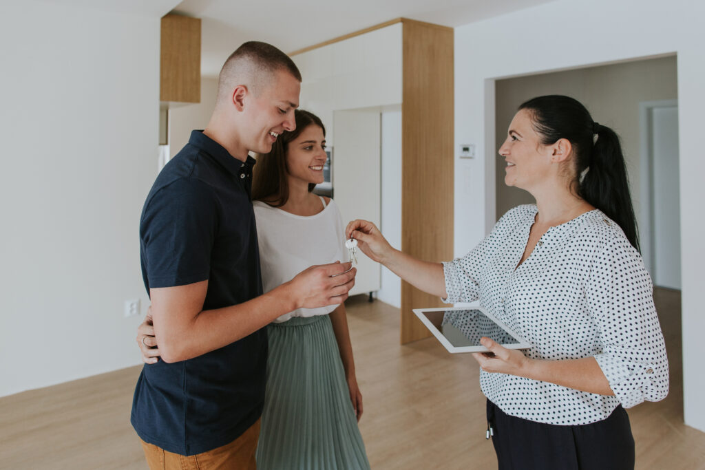 Rental property manager giving keys to new tenants